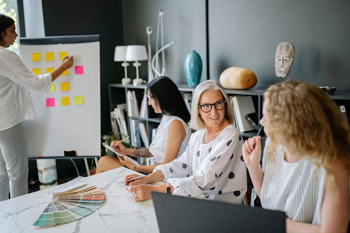 Women sitting at the meeting table while having a discussion