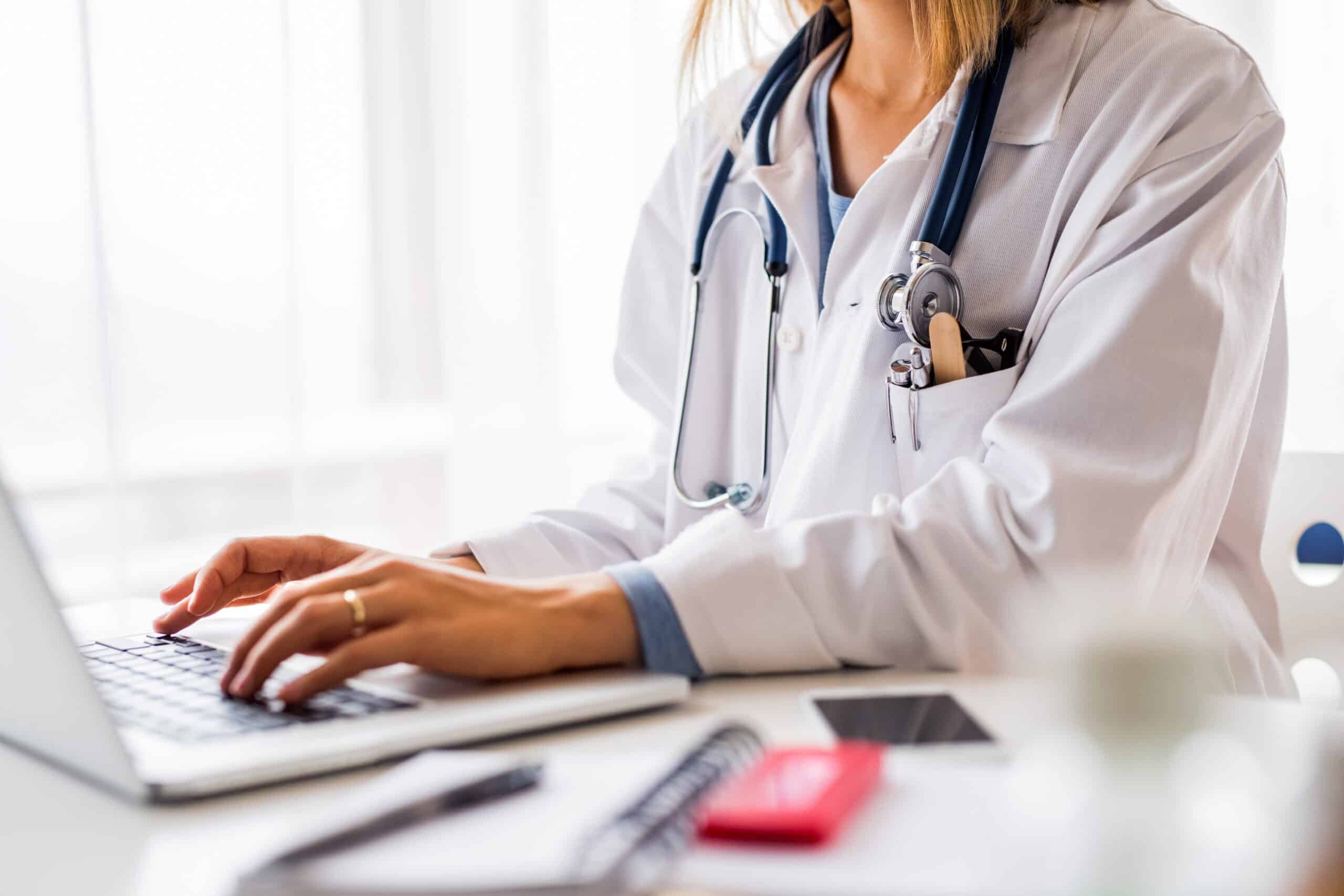 female doctor working on laptop at the office desk