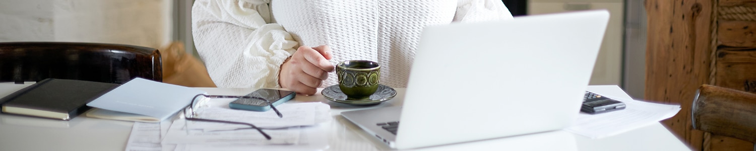 person sits in front of open laptop