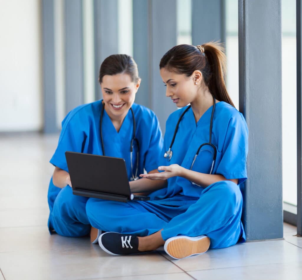 two nurses using laptop computer during break